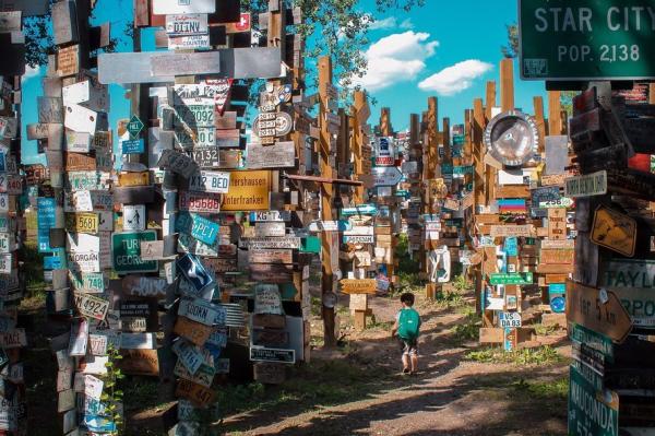 A child walks through the Sign Post Forest in Watson Lake