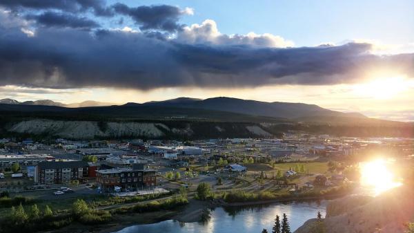 The summer sun sets over downtown Whitehorse and the Yukon River