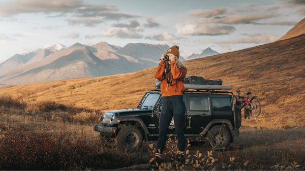 Woman with camera in wilderness