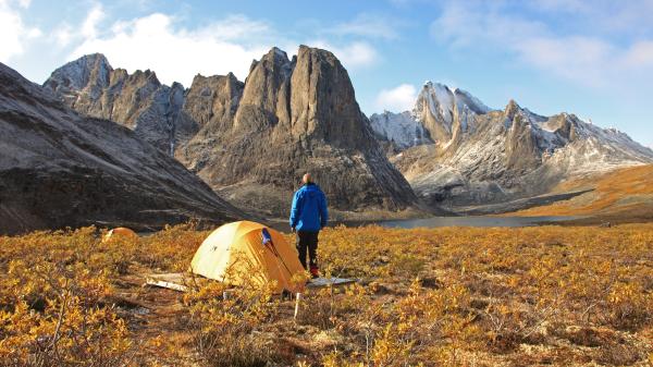 A backcountry camper takes in the spectacular view at Tombstone Territorial Park