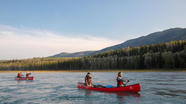Two couples paddling on a Yukon river.