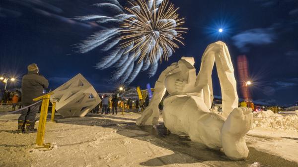 Fireworks burst to life over snow  sculptures
