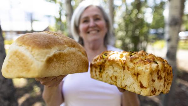 Woman holding two loaves of bread 