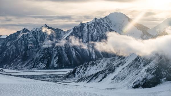 Kluane icefields and a sunbeam among clouds