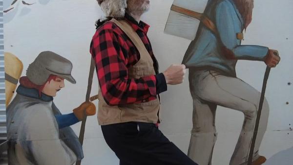 Tin Cup posing with depicted stampeders at Klondike Gold Rush National Historical Park in Skagway, Alaska.