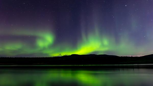 Northern lights reflecting on a lake.