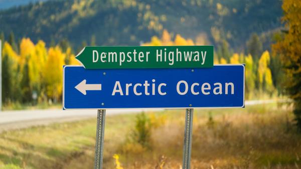 A sign on highway indicating arctic ocean 
