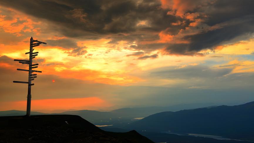 The sun sets over Keno from the top of Keno Hill sign post