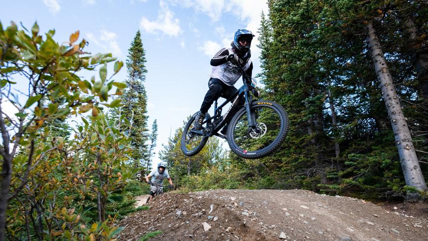 Mountain biker mid air over jump