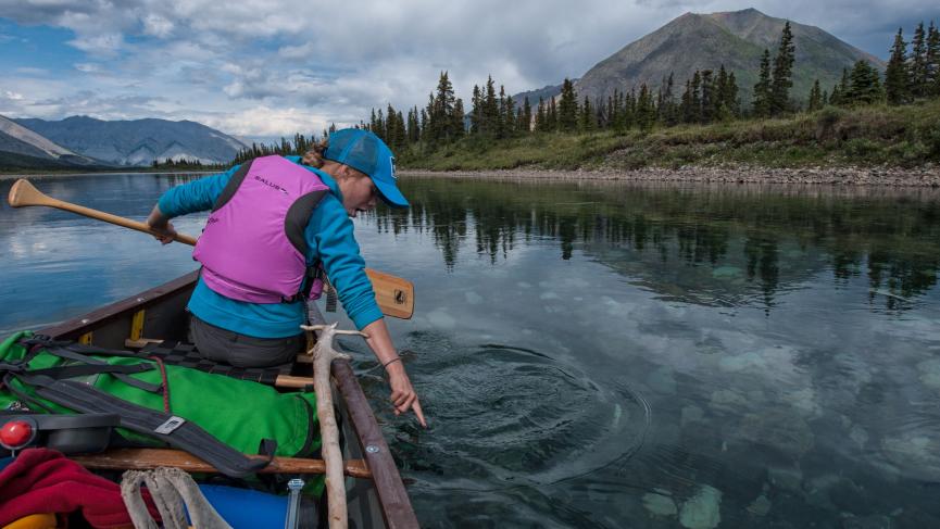 Canoe on clear yukon water in backcountry.