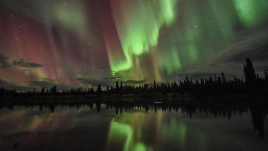 northern lights reflecting in Takhini River