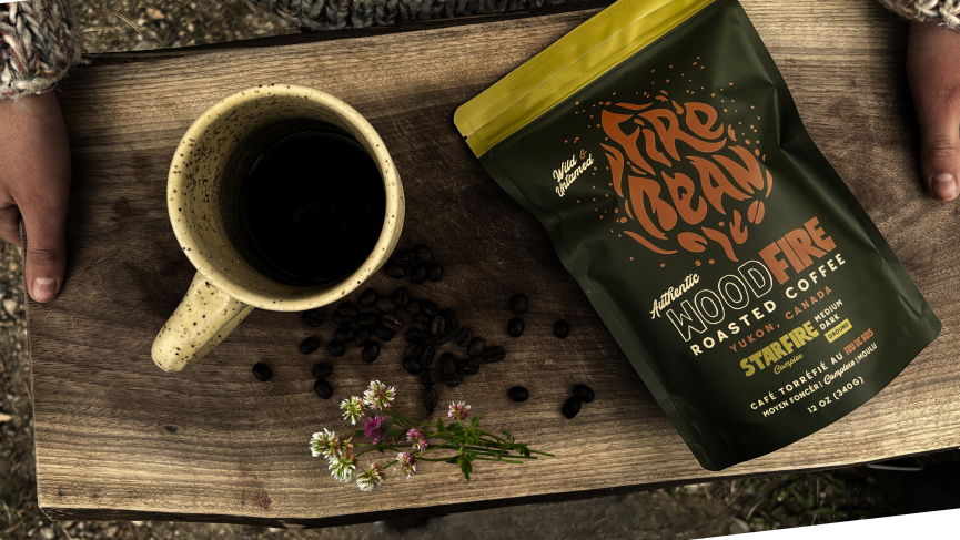 Firebean Coffee bag on a cutting board with a clay mug