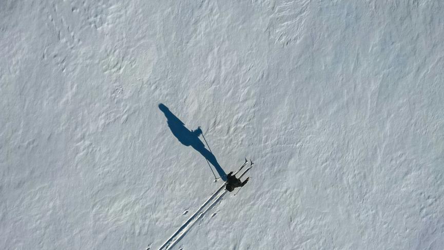 Skier on frozen lake