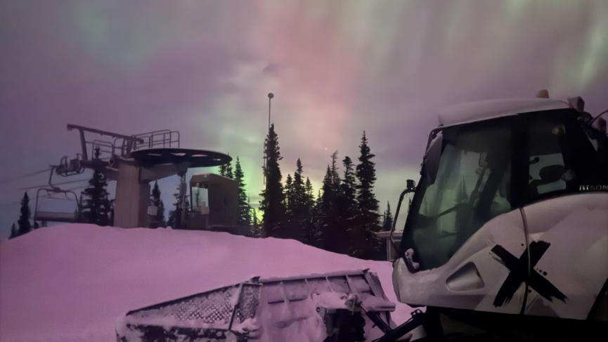 Northern lights above Snowcat from top of Mount Sima
