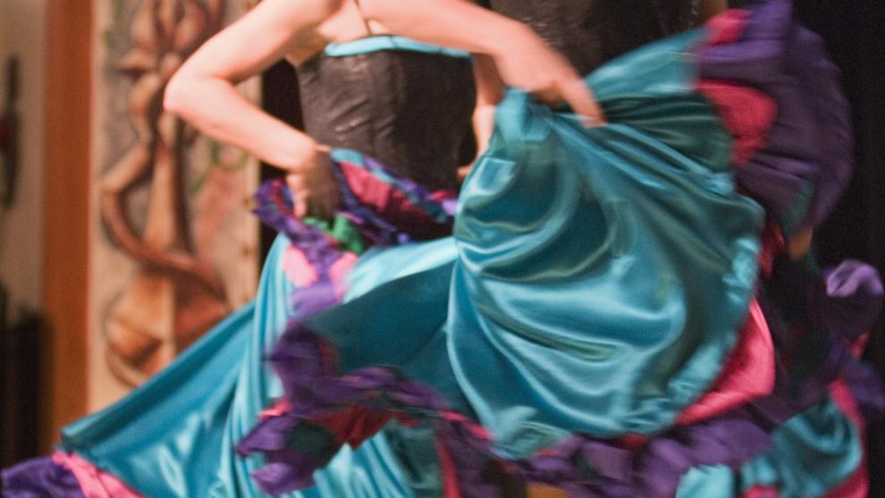 can can dancers in teal skirts dance on stage