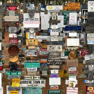 A collection of road and business signs 