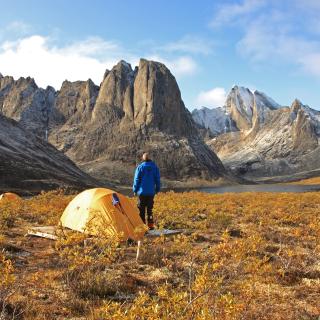 A backcountry camper takes in the spectacular view at Tombstone Territorial Park