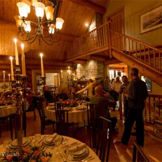 People gathering in the foyer of a wood cabin