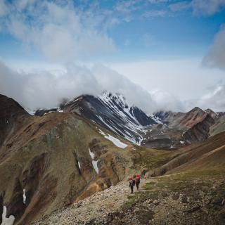Hikers traverse a mountainside in Kluane National Park and Reserve