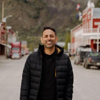 Rishad smiling in the middle of the street in Dawson City