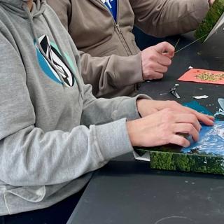 participants bead photos in a workshop with Pat Bragg