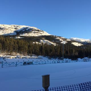 sun on Grey Mountain behind range