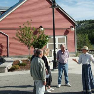 People stand in front of a museum on an interpretive tour