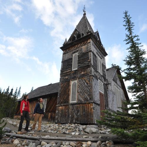 A couple enjoys a tour at St. Andrew's Church, along the Chilkoot trail.