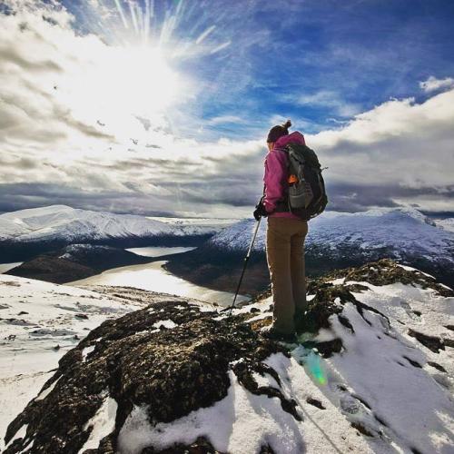 A hiker on top of a wintry summit
