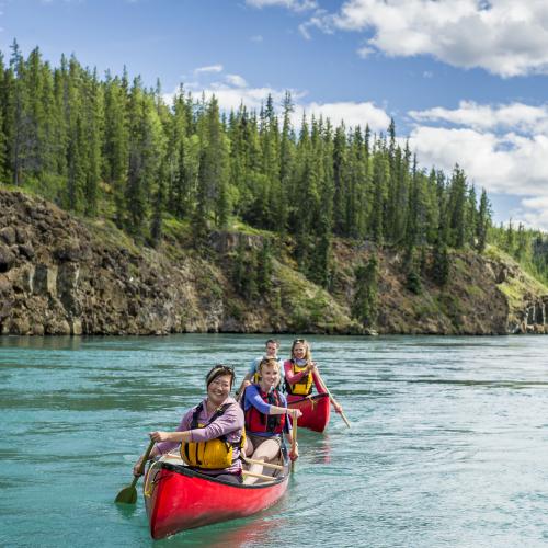 Paddlers enjoy a canoe ride through Miles Canyon