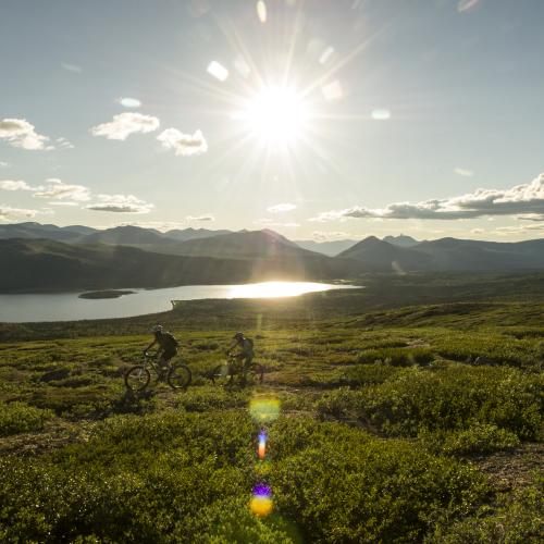Two mountain bikers ride Mount McIntyre overlooking Fish Lake