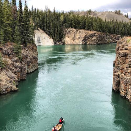 A paddler canoes through Miles Canyon