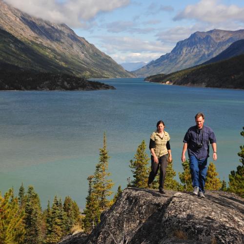 A couple walks along Bennett Lake