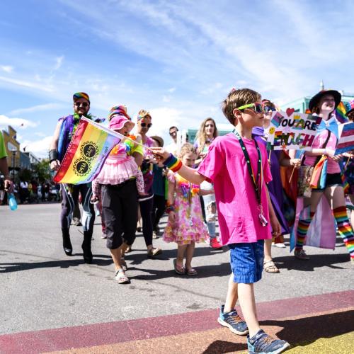 A parade of people celebrate Yukon Pride