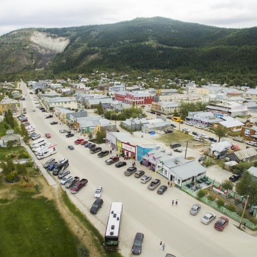 An aerial view of Dawson City and mountains