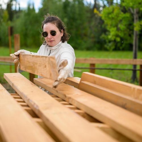 Rugged apprentice building a picnic table
