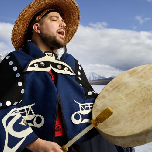 Gary singing and beating a drum