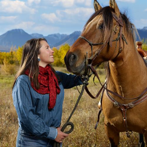 Woman looking lovingly at her horse