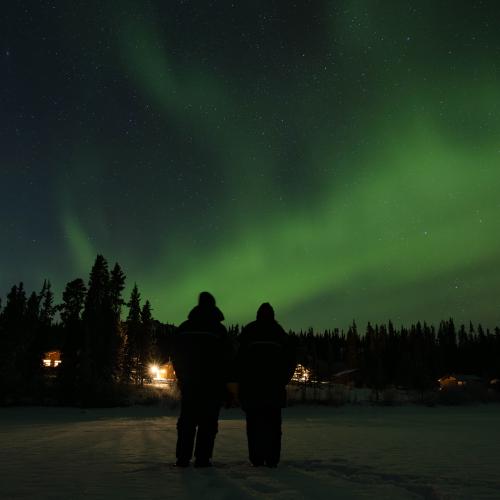 A couple looking at Northern Lights