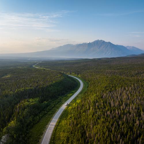 An RV driving towards Mount Martha Black and the Auriol Range, west of Haines Junction.