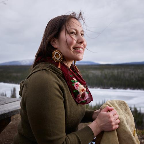 Geri-lee holding moose hide while smiling. 