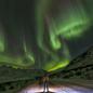 Person standing under the northern lights 
