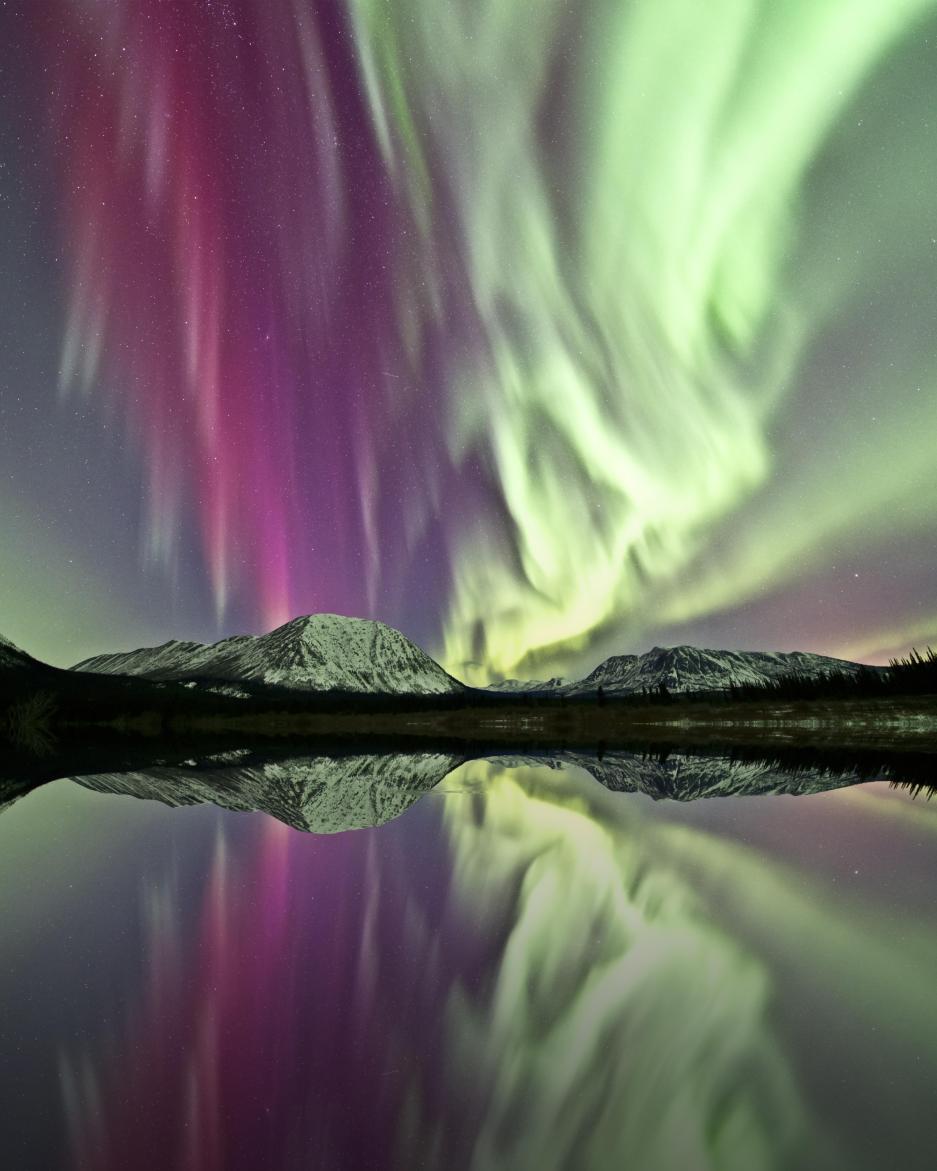 northern lights over mountains and a lake