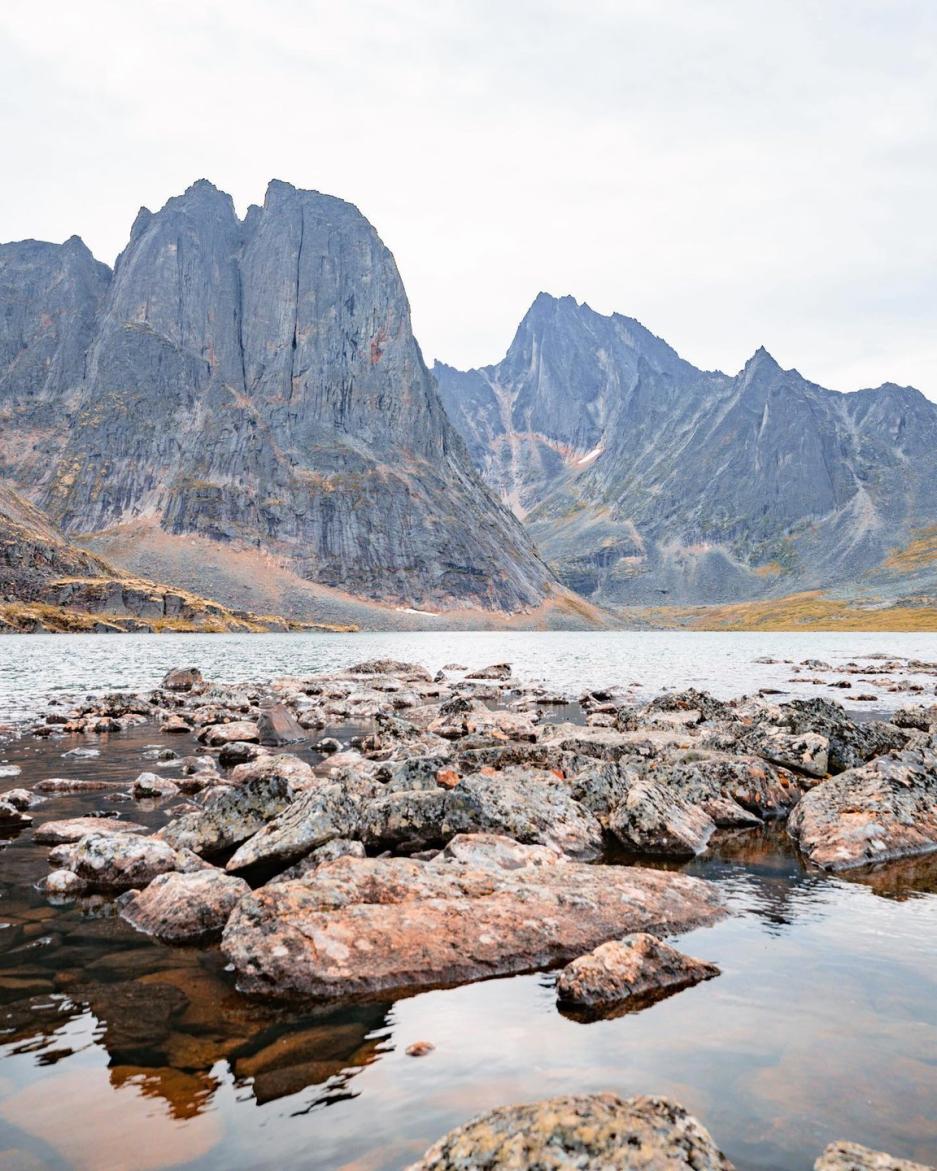 Large mountain and rocks by a lake