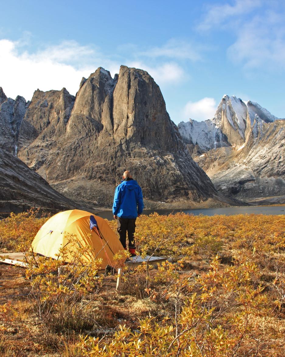 A backcountry camper takes in the spectacular view at Tombstone Territorial Park