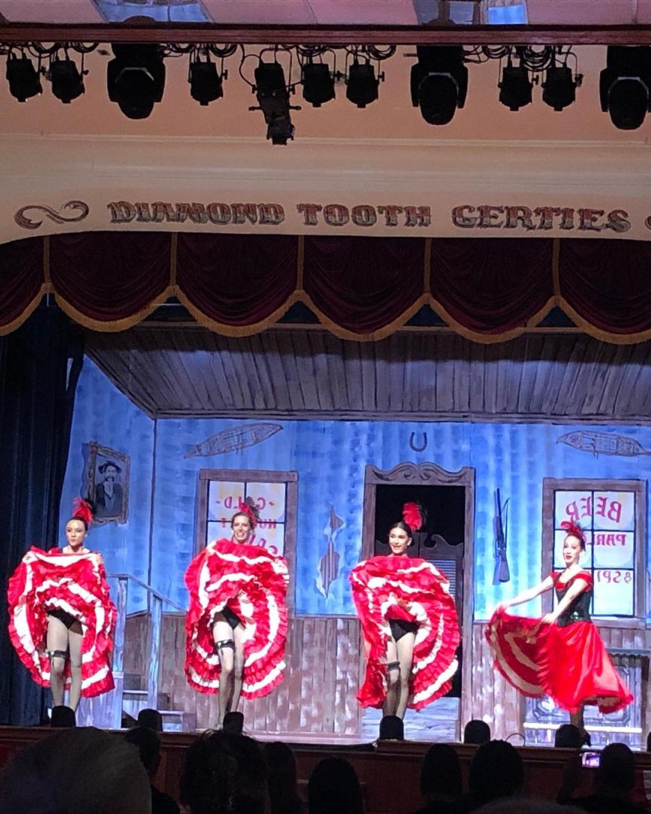 gertie's can can dancers on stage in red and white skirts