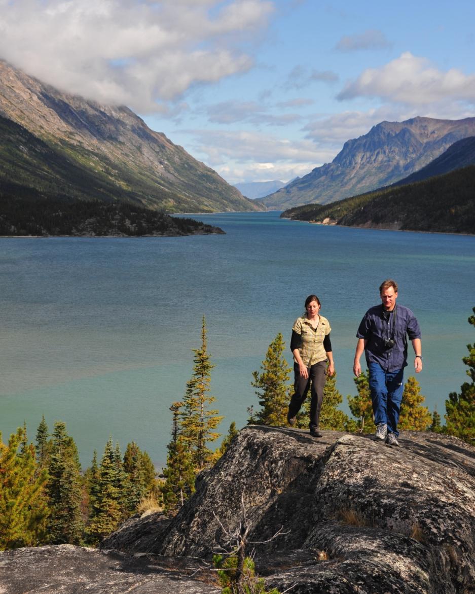 A couple walks along Bennett Lake