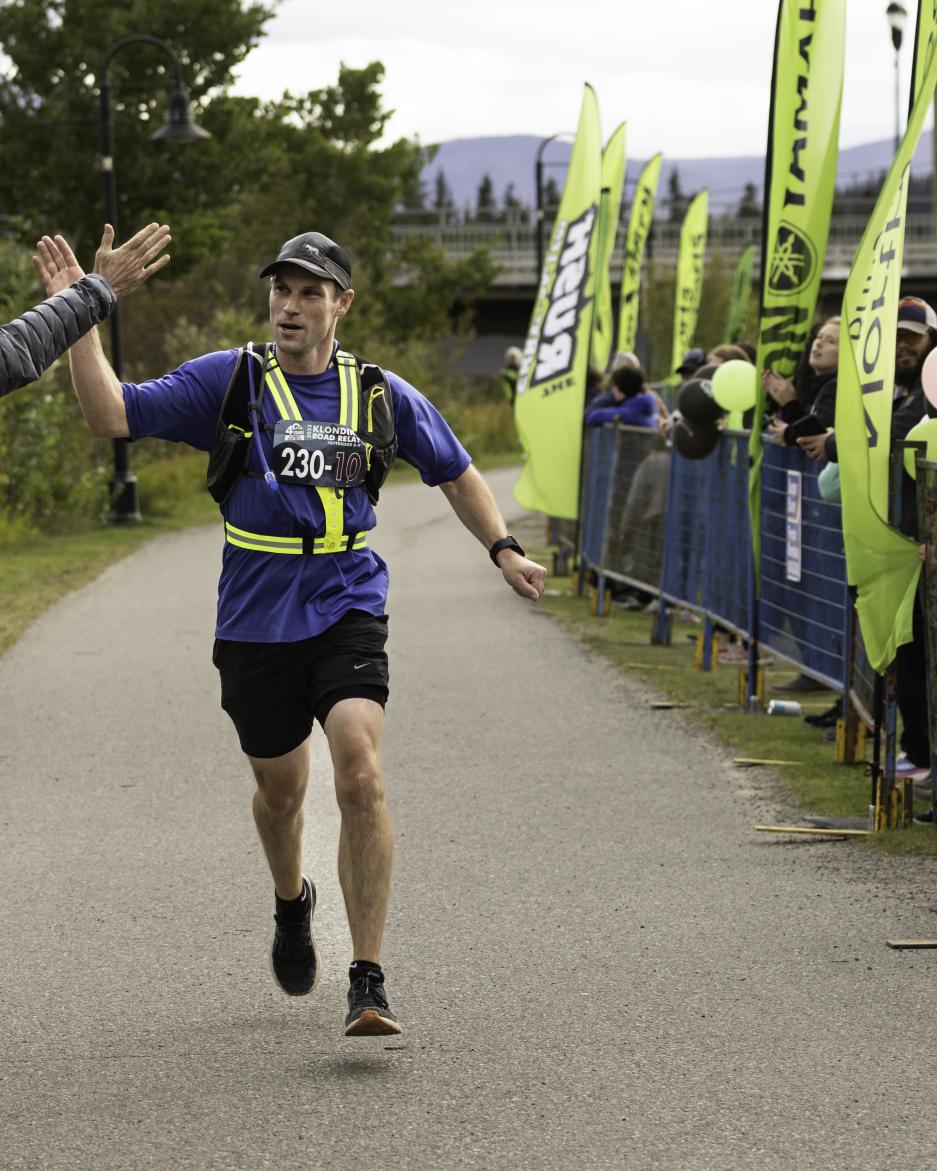man crossing finish line