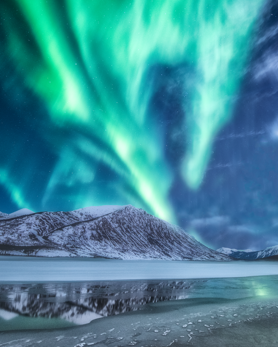 solar max aurora above a half frozen lake