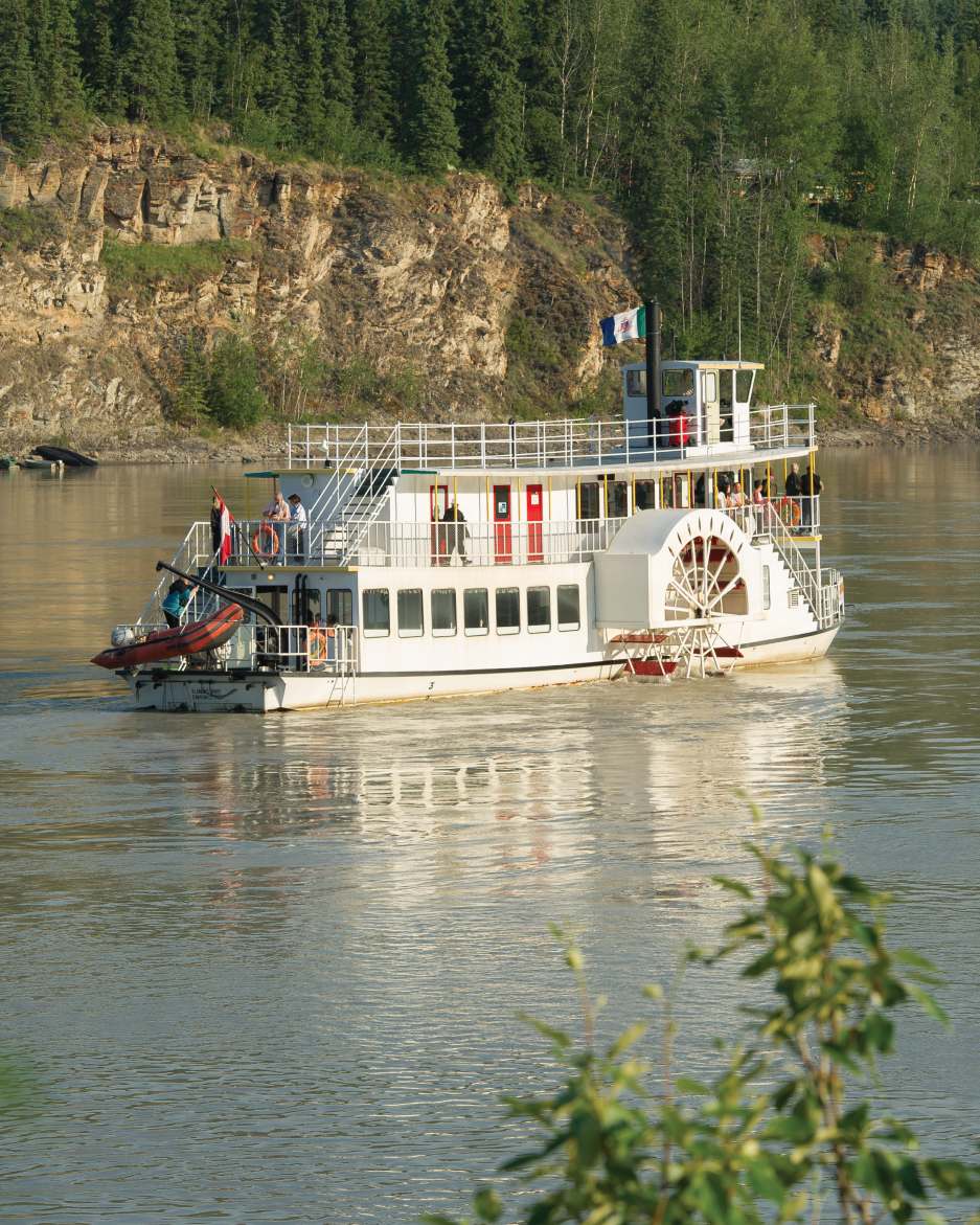 A paddle steamer-style boat on a lake